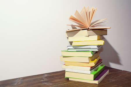 Stack of books on dark rustic table. Free space for textの写真素材