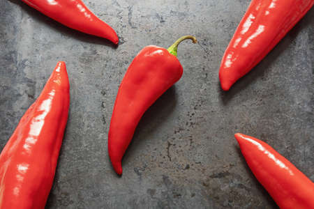 Bright red sweet peppers on dark baking sheet. Flat lay, free space for textの写真素材