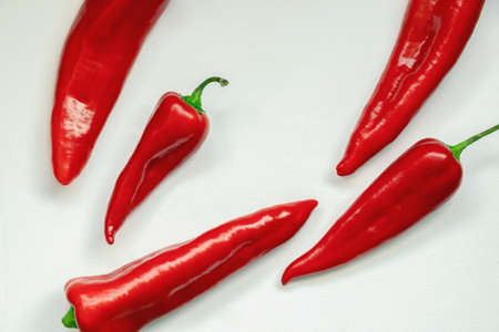 Bright red sweet peppers on white table. Flat lay, free space for textの写真素材
