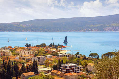 Beautiful  Mediterranean landscape  on sunny spring day.  Montenegro, Adriatic Sea, view of Bay of Kotor near Tivat city. Sailboats on waterの写真素材