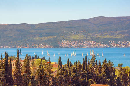 Beautiful  sunny Mediterranean landscape. Sailboats on water. Montenegro, Adriatic Sea, view of Bay...