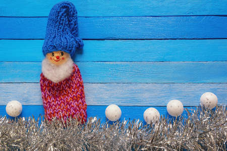 Christmas and New Year background. Funny gnome and Christmas balls on blue rustic table. Flat lay. Free space for textの写真素材