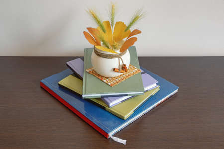 School concept. Stack of books on dark table. Autumn leaves. Copy spaceの写真素材