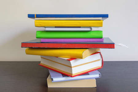 School concept. Stack of colorful  books on dark table. Free space for textの写真素材