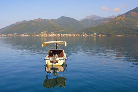 Summer Mediterranean landscape. Montenegro, Adriatic Sea. View of Kotor Bay near Tivat city. Fishing boat on the waterの写真素材