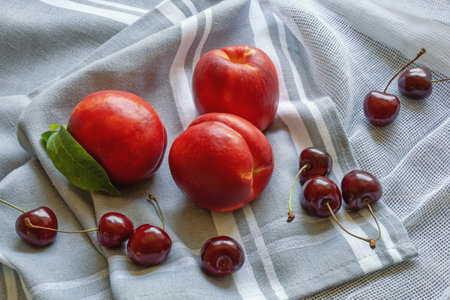 Red summer fruits. Fresh ripe cherries and nectarines on tableの写真素材