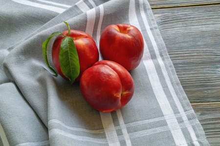 Red fruits. Fresh ripe nectarines on rustic table. Flat lay, copy spaceの写真素材