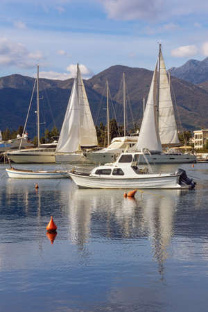 Beautiful winter Mediterranean landscape. Sailboats and fishing boats on water. Montenegro, Adriatic Sea. View of Kotor Bay near Tivat cityの写真素材