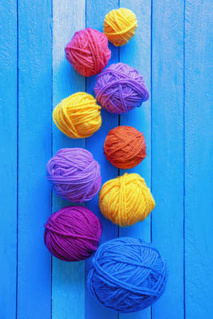 Hobbies and knitting concept.   Colorful balls of wool on  blue rustic background. Copy spaceの写真素材
