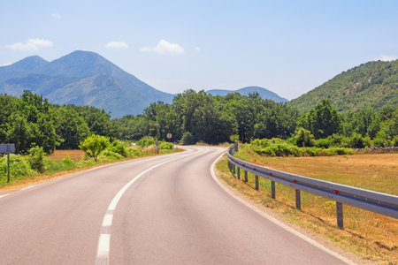Balkan road trip.  Sunny summer landscape with road in valley of Dinaric Alps.  Bosnia and Herzegovina, Republika Srpskaの写真素材