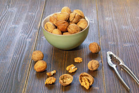 Nuts. Whole walnuts and kernels on dark rustic table. Space for textの写真素材