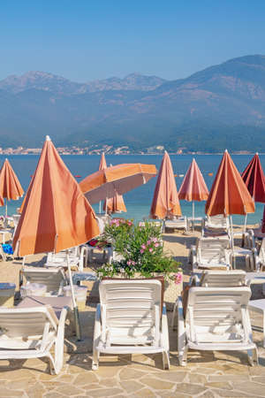 Beach vacation concept. Beautiful Mediterranean landscape with beach umbrellas. Montenegro, Adriatic Sea, Kotor Bayの写真素材