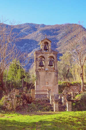 Religious architecture.  Separate belfry. Prcanj town, Montenegro.  View of Belfry of Birth of Our Lady Church on sunny winter dayの写真素材