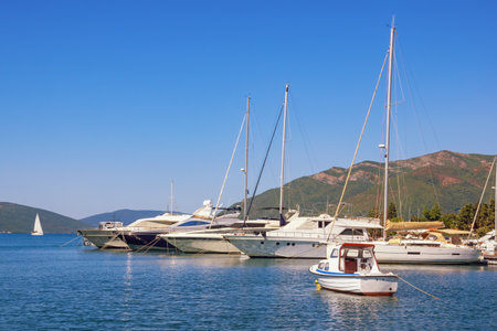 Beautiful  Mediterranean landscape. Sailboats and fishing boats on water. Montenegro, Adriatic Sea. View of Kotor Bay near Tivat cityの写真素材