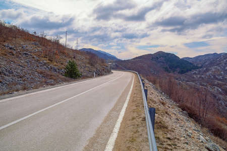 Balkan road trip.  Beautiful overcast landscape with road in Dinaric Alps mountains. Bosnia and Herzegovina, Republika Srpskaの写真素材