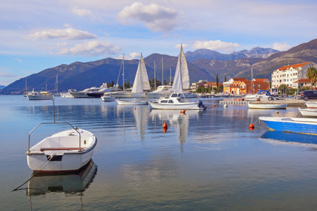 Beautiful winter Mediterranean landscape. Sailboats and fishing boats on water. Montenegro, Adriatic Sea. View of Kotor Bay near Tivat cityの写真素材