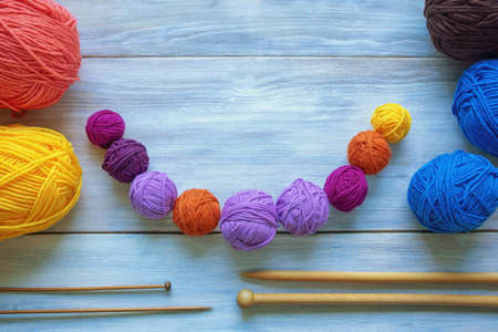 Hobbies and knitting concept. Colorful balls of wool and  knitting needles on rustic table. Copy spaceの写真素材