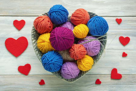 Colorful balls of wool and  knitting needles on rustic table. Hobbies and knitting concepts.  Valentinesの写真素材