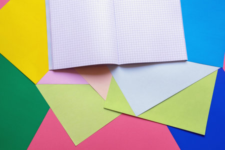 School and hobby concepts. Colored paper sheets and notebook. Copy spaceの写真素材