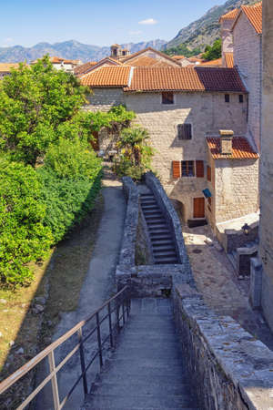 Montenegro. View of Old Town of Kotor, UNESCO World Heritage Site. Staircase of ancient fortifications, red roofs and street of Old Townの写真素材