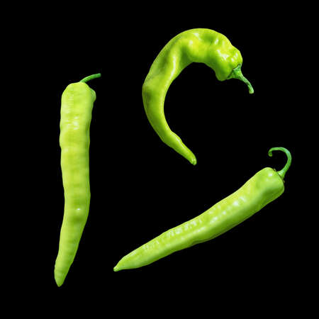 Bright green hot peppers, isolated  on blackの写真素材