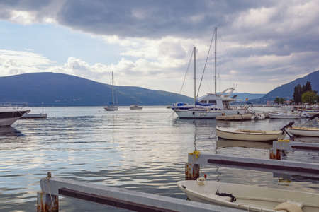 Sailboats and fishing boats on water. Autumn Mediterranean landscape. Montenegro, Adriatic Sea. View of Kotor Bay near Tivat cityの写真素材