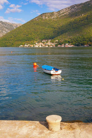 Beautiful Mediterranean landscape on sunny autumn day. Fishing boat on water. Montenegro, Adriatic Sea. Coast of Kotor Bay near Verige Straitの写真素材