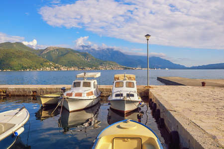 Beautiful Mediterranean landscape on sunny autumn day. Fishing boats in small harbor. Montenegro, Adriatic Sea. Coast of Bay of Kotor near Bijela town ( Herceg Novi )の写真素材