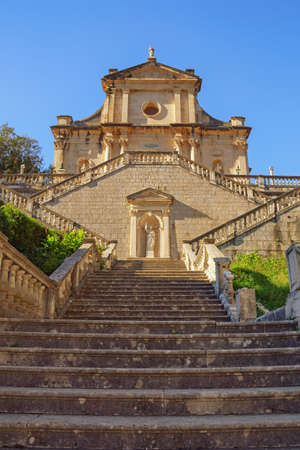 Religious architecture. Venetian baroque style. Montenegro. View of ancient Catholic church of Birth of Our Lady in Prcanj town on sunny autumn dayの写真素材