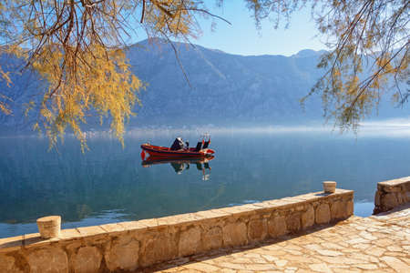 Calm autumn morning, beautiful Mediterranean landscape. Montenegro, Adriatic Sea. View of Bay of Kotor from embankment of town of Prcanj (Kotor)の写真素材