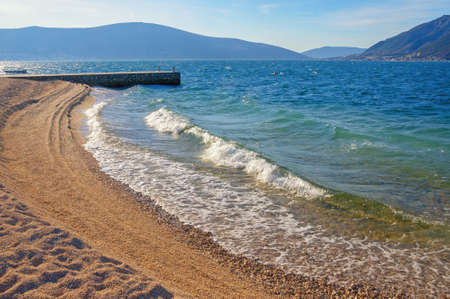 Winter beach, beautiful sunny Mediterranean landscape. Montenegro, Adriatic Sea, view of Bay of Kotor near Tivat cityの写真素材