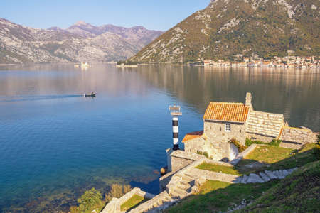 Sunny autumn Mediterranean landscape. Montenegro, Adriatic Sea. View of Kotor Bay, two small islands  and ancient Church of Our Lady of  Angelsの写真素材