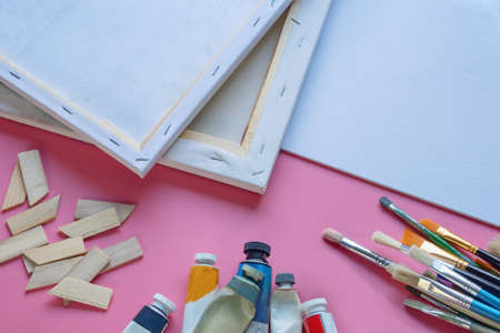 Canvas, oil paint tubes and paintbrushes. Education and art concepts. Copy spaceの写真素材