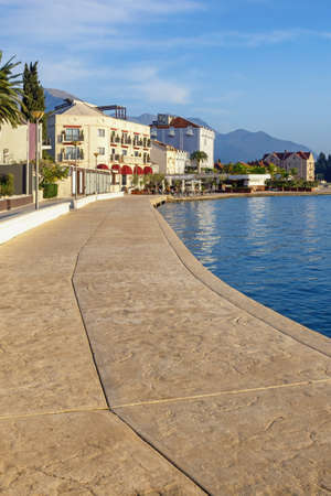 Beautiful autumn Mediterranean landscape. View of embankment of Tivat city on sunny autumn day. Montenegro, Adriatic Sea, Bay of Kotorの写真素材