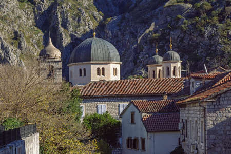 Religious architecture. Domes of churches. Montenegro. View of Old Town of Kotor on sunny November dayの写真素材