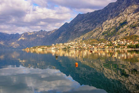Beautiful winter Mediterranean landscape.  Montenegro, Adriatic Sea. View of Kotor Bay near Kotor city.  Mountains and clouds are reflected in waterの写真素材