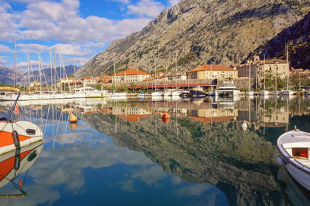 View of marina near Old Town of Kotor on sunny winter day.  Mountains, boats  and walls of Kotor Old...