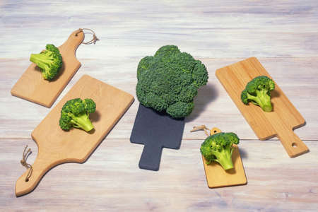 Green vegetables. Fresh broccoli on different cutting boards.  Rustic table. Free space for textの写真素材