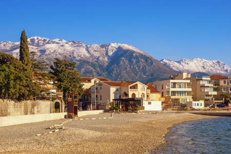 Beautiful winter Mediterranean landscape. Montenegro, Kotor Bay. View of Tivat town and snow-capped Lovcen mountainの写真素材