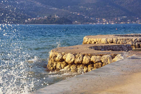 Beautiful Mediterranean landscape. Winds of Adriatic Sea. Montenegro, coast of Kotor Bay. Embankment of Donja Lastva village near Tivat city. Mandrac (mandrach) -  dry stone jetty, cultural heritage of Kotor Bayの写真素材