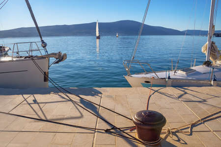 Beautiful Mediterranean landscape. Montenegro, Kotor Bay. Embankment of Tivat city, sailing boats on the waterの写真素材