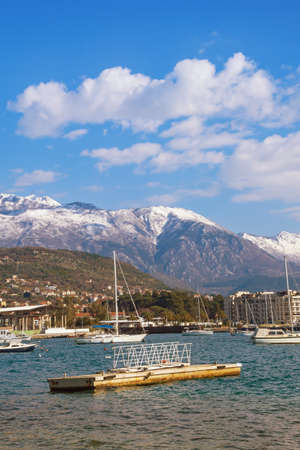 Beautiful winter Mediterranean landscape. Montenegro, Adriatic Sea, Bay of Kotor. View of snow-capped peaks of Lovcen mountain and Tivat cityの写真素材