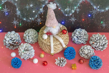 Funny gnome and Christmas  decorations.  Bright garland lights - double exposure. Christmas conceptsの写真素材