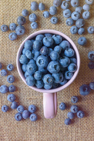Fresh ripe whortleberries on table. Flat lay. Copy spaceの写真素材