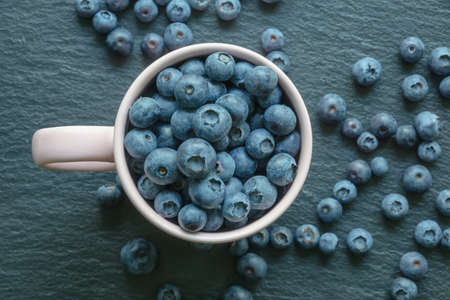 Fresh ripe whortleberries on black table. Flat lay. Copy spaceの写真素材