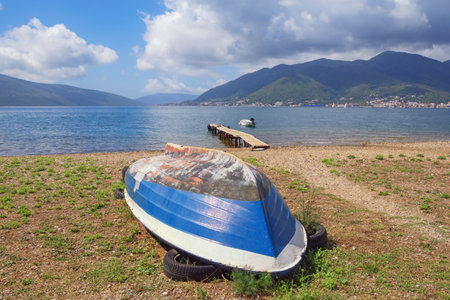 Old fishing boat on coast of Kotor Bay on sunny autumn day. Montenegro,  Adriatic Sea,  Tivatの写真素材
