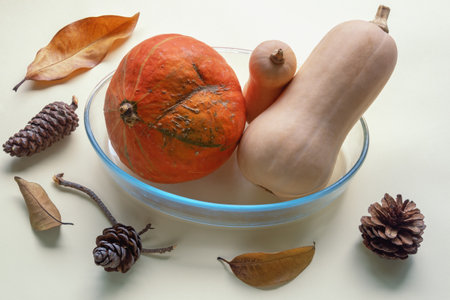 Autumn concepts. Pumpkins, dry autumn leaves , pine conesの写真素材