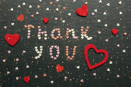 Word Thank you from small colorful hearts. Light garland, double expositionの写真素材