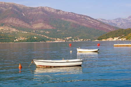 Beautiful autumn Mediterranean landscape  - mountains, sea and fishing boats on water.  Montenegro, Adriatic Sea, Bay of Kotor, Tivatの写真素材
