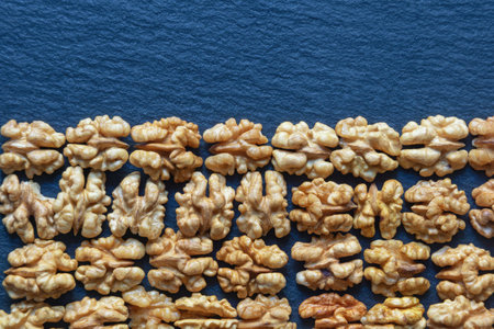 Walnut kernels on black table, background. Flat lay, copy spaceの写真素材